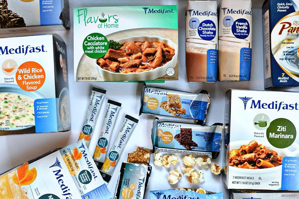 Variety of foods including wild rice and chicken flavored soup and ziti marinara among others are packed in the boxes of medifast Inc.