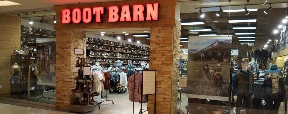 This is the entrance of a well organized retail store by Boot Barn Holding Inc. showing a variety of merchandise.