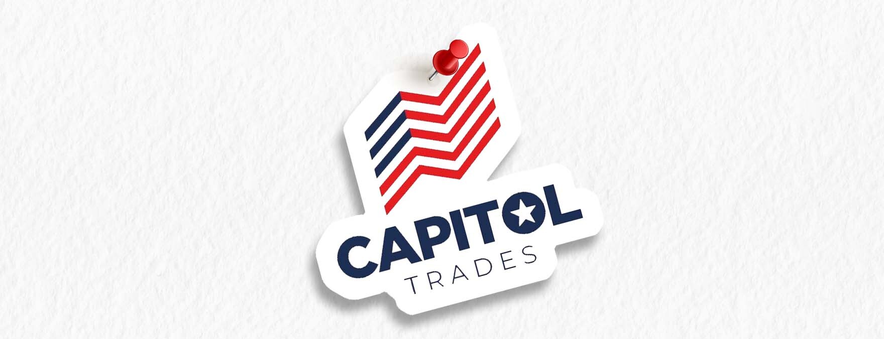 With a board pin, the Capitol Trades emblem is affixed on a white notice board.