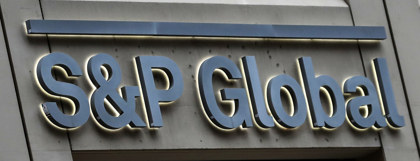 The logo of S&P Global Inc. in bluish grey color is displayed in a building's wall