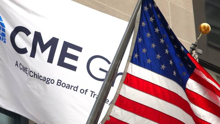 The image depicts two flags, one of which is the flag of the United States and the other of which is the flag of CME Group Inc.