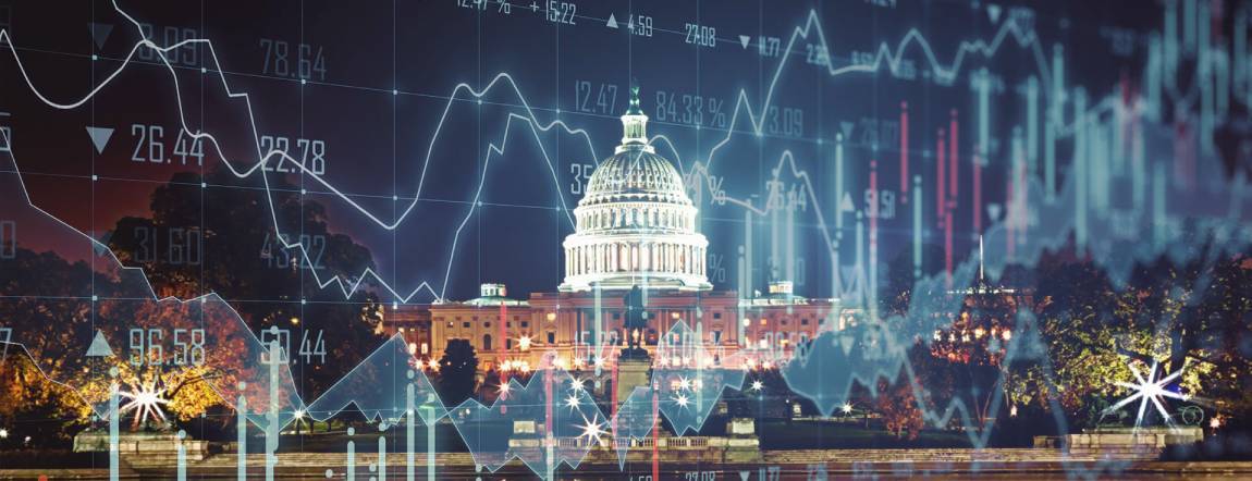 Picture of Capitol Hill taken during night time with blurred stock market charts on top