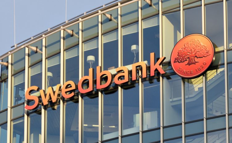 In the blue mirror building, there is an orange swedbank emblem.
